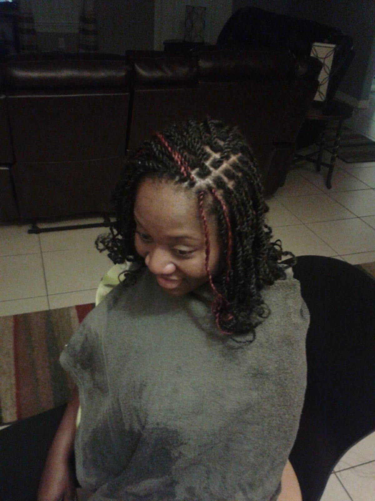 Front view of black braid hairstyle with 4 red extensions