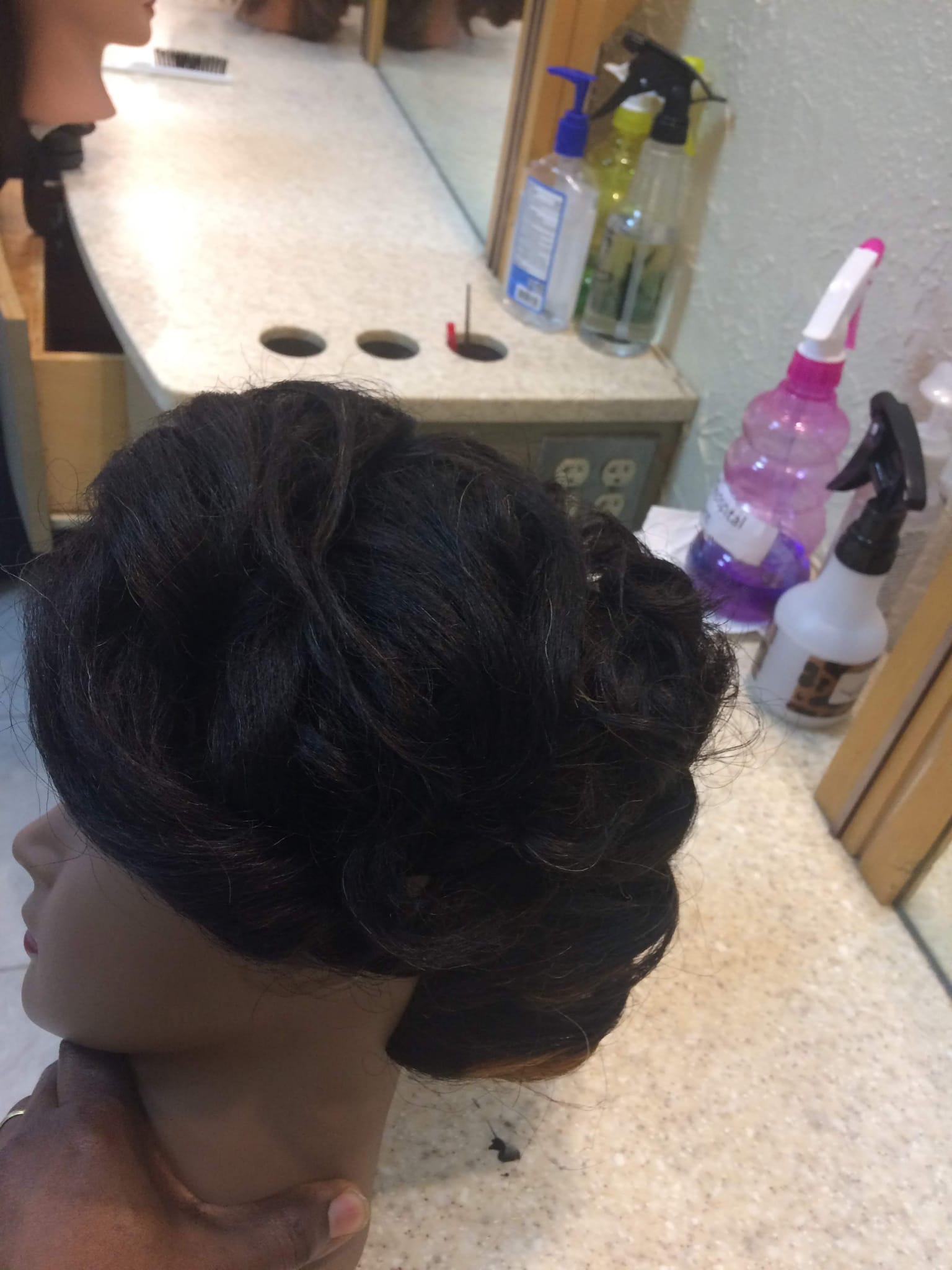 Mannequin with black bridal updo hairstyle